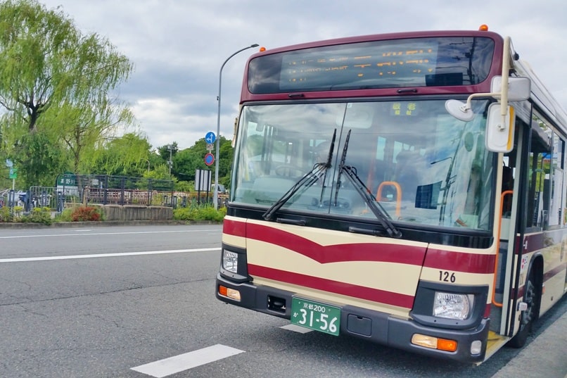 Getting around Kyoto by bus. kyoto bus red. Backpacking Japan travel blog